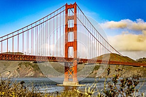 Golden Gate Bridge in the city of San Francisco, in the state of California in the USA, crossing the bay and under a blue sky.