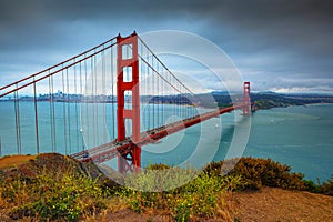 Golden Gate Bridge on a cloudy day with San Francisco skyline in the background