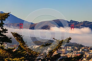 Golden Gate Bridge peeks out from the fog in San Francisco