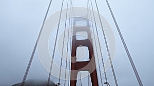 Golden Gate Bridge in San Francisco in Fog Looking Up from a Car Roof at the Overcast Weather Day