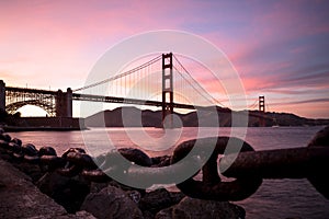 Golden Gate Bridge in San Francisco silhouette against sunset sk