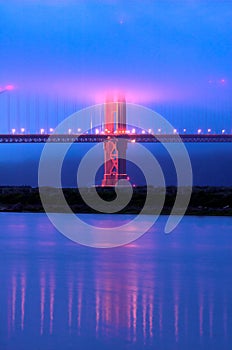 Golden Gate Bridge under fog at dusk