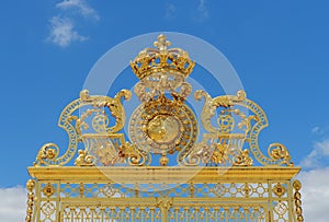 Golden gate of Chateau de Versailles with blue sky - Versailles, France