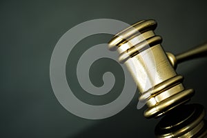 Golden gavel on wooden table,legal books background