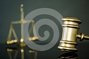 Golden gavel on wooden table,legal books background