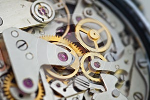 Golden gears in an iron mechanism. Macro. The concept of Time, Teamwork, Idea Technology, Infinity, Success, Business