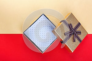 Golden gift box on red background.Top view flat lay group objects