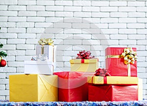 Golden gift box and red ribbon on color background