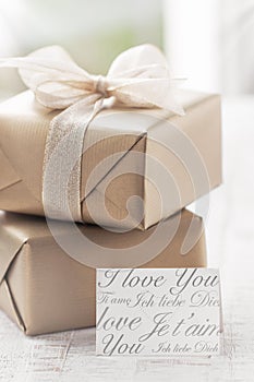 Golden gift boxes with beautiful ribbon and bow on a bright shiny background