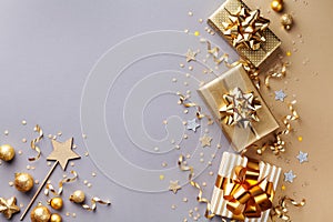 Golden gift or present boxes with golden bows and confetti top view. Christmas background. Flat lay