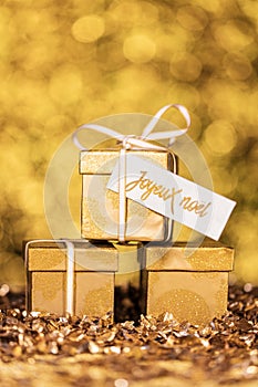 Golden gifts with french text which means merry christmas