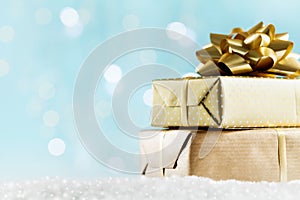 Golden gifts or presents boxes on magic bokeh background. Holiday composition for Christmas or New Year.