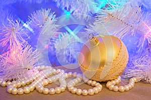 Golden glass Christmas bauble with natural pearl garland