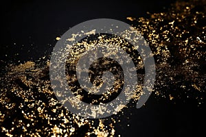 Golden glitter on a black background,  Golden sparkles on a black background