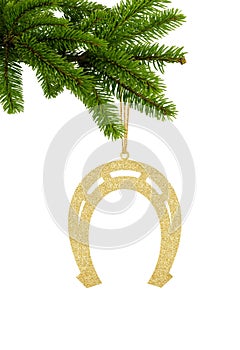 Golden Glitter Decorative Horseshoe on Green Christmas Fir Tree isolated on White