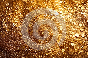 Golden glitter fills the frame, composed of variously sized, reflective hexagonal photo