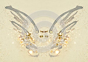 Golden glitter and glittering stars on abstract black watercolor wings in vintage nostalgic colors