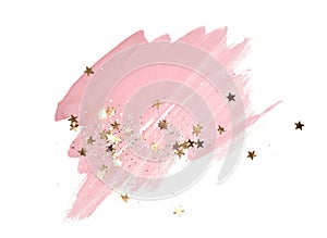 Golden glitter and glittering stars on abstract pink watercolor splash on white background