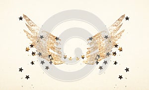 Golden glitter and glittering stars on abstract watercolor wings in vintage nostalgic colors