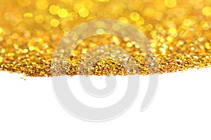 The golden glitter sand texture handful spread on white, abstract background with copy space