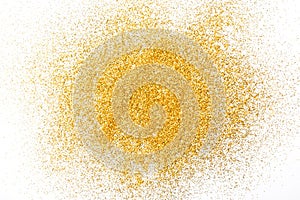 Golden glitter sand texture on white, abstract background.