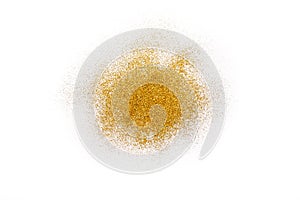 Golden glitter sand texture on white, abstract background.