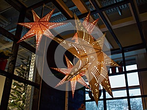 Golden glittering star shaped Christmas paper ornament