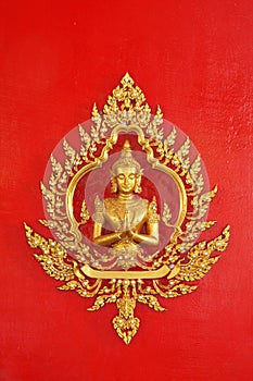 Golden god (Deva) on the red wall Thai art