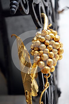 Golden grape vine on forged grates