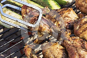 Golden Grilled Wings On Charcoal Grill Being Flipped With Tongs