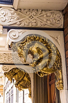Golden grotesque stone golden satyrfaun, architectural detail of the medieval building