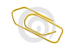 Golden grounge paper clip isolated on white background close up