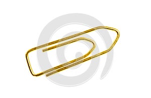 Golden grounge paper clip isolated on white background close up