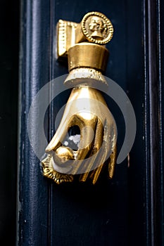 Golden hand holding a door knob