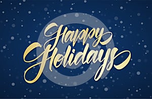 Golden handwritten calligraphic brush lettering of Happy Holidays on winter snowy sky background with snowflakes