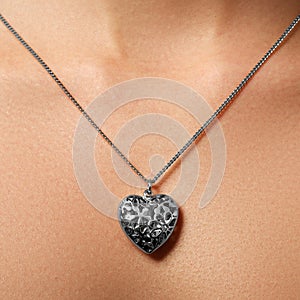 Golden heart pendant. Beauty and jewelry concept. Woman wearing