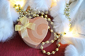 Golden Heart Shape Present Box on Red and White Background