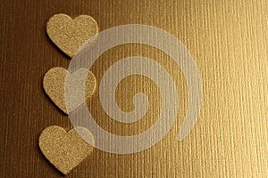 Golden hearts on a golden background