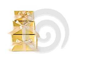 Golden holiday gifts. Gold bar. White background. Satin ribbon a