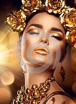 Golden holiday makeup. Fashion art hairstyle, manicure and makeup