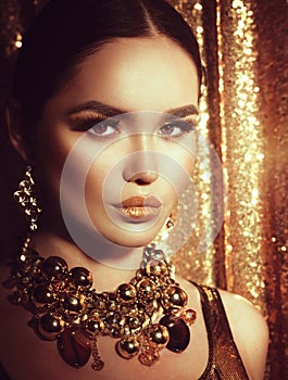 Golden holiday makeup. Fashion art hairstyle, manicure and makeup