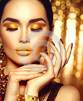 Golden holiday makeup. Fashion art manicure and makeup