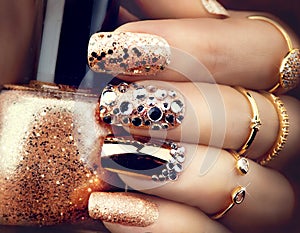 Golden holiday style bright manicure with gems and sparkles