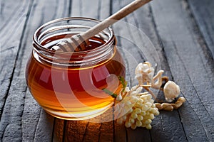 Golden honey glistening invitingly in glass jar