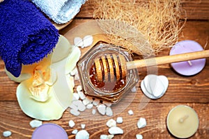 Golden honey jar, orchid flowers, towels and aromatic candles
