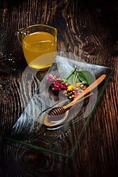 Golden honey on plate and colorful flowers