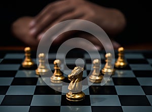 Golden horse, knight chess piece and gold pawn chess pieces on chessboard with businessman on dark background. Leadership,