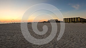 Golden hour beach distant hotels and people