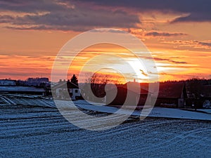 Golden hour by dawn in country village winter season landscape