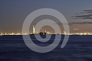 Golden hour night photography of the Verrazano Narrows Bridge, New York harbor, statue of Liberty seen from the Battery Park NYC